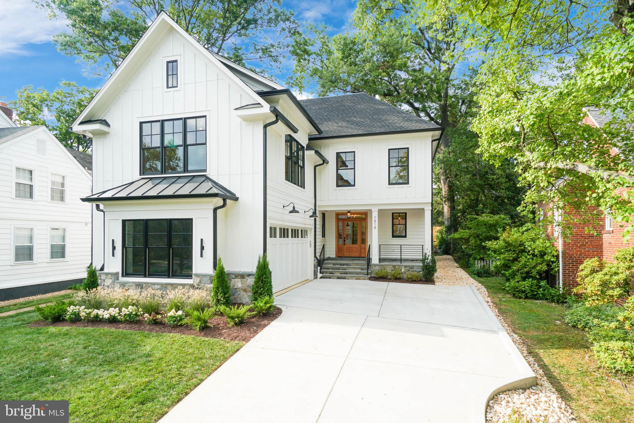 7818 Glenbrook Road Bethesda, MD 20814 - Photo 2 of 95 a front view of a house with a yard and garage