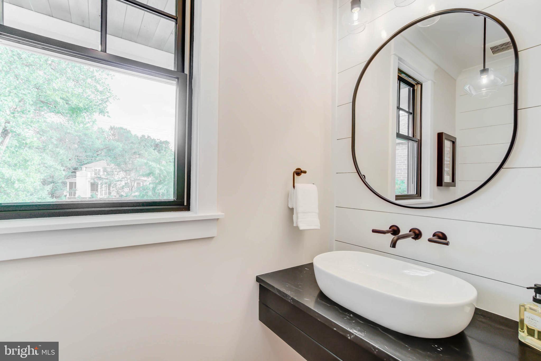 7818 Glenbrook Road Bethesda, MD 20814 - Photo 30 of 95 a bathroom with a sink and a mirror