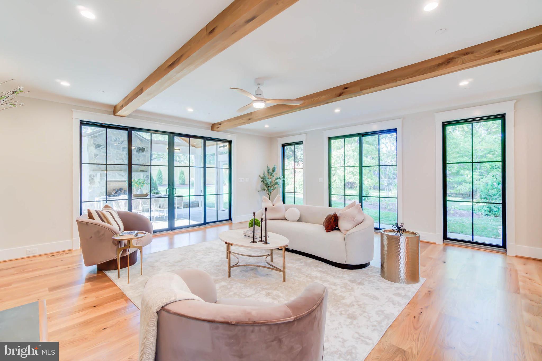 7818 Glenbrook Road Bethesda, MD 20814 - Photo 32 of 95 a living room with furniture and floor to ceiling windows
