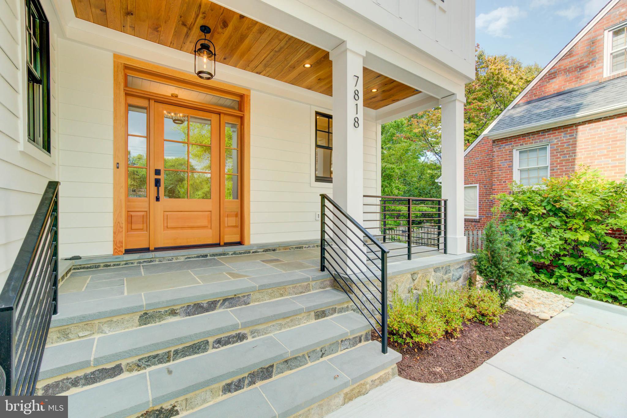 7818 Glenbrook Road Bethesda, MD 20814 - Photo 4 of 95 a front view of a house with a garden