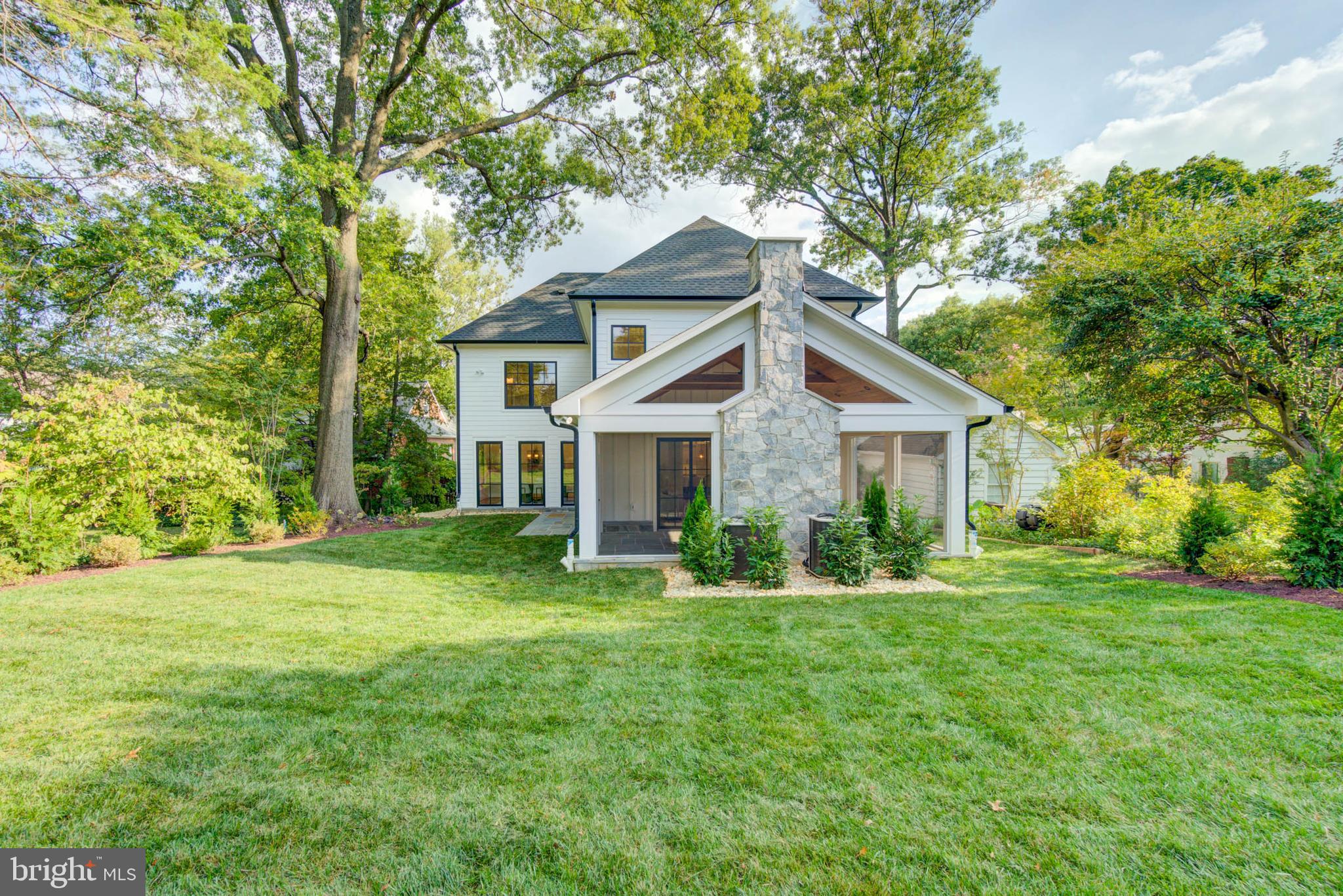 7818 Glenbrook Road Bethesda, MD 20814 - Photo 45 of 95 a front view of a house with a yard and trees