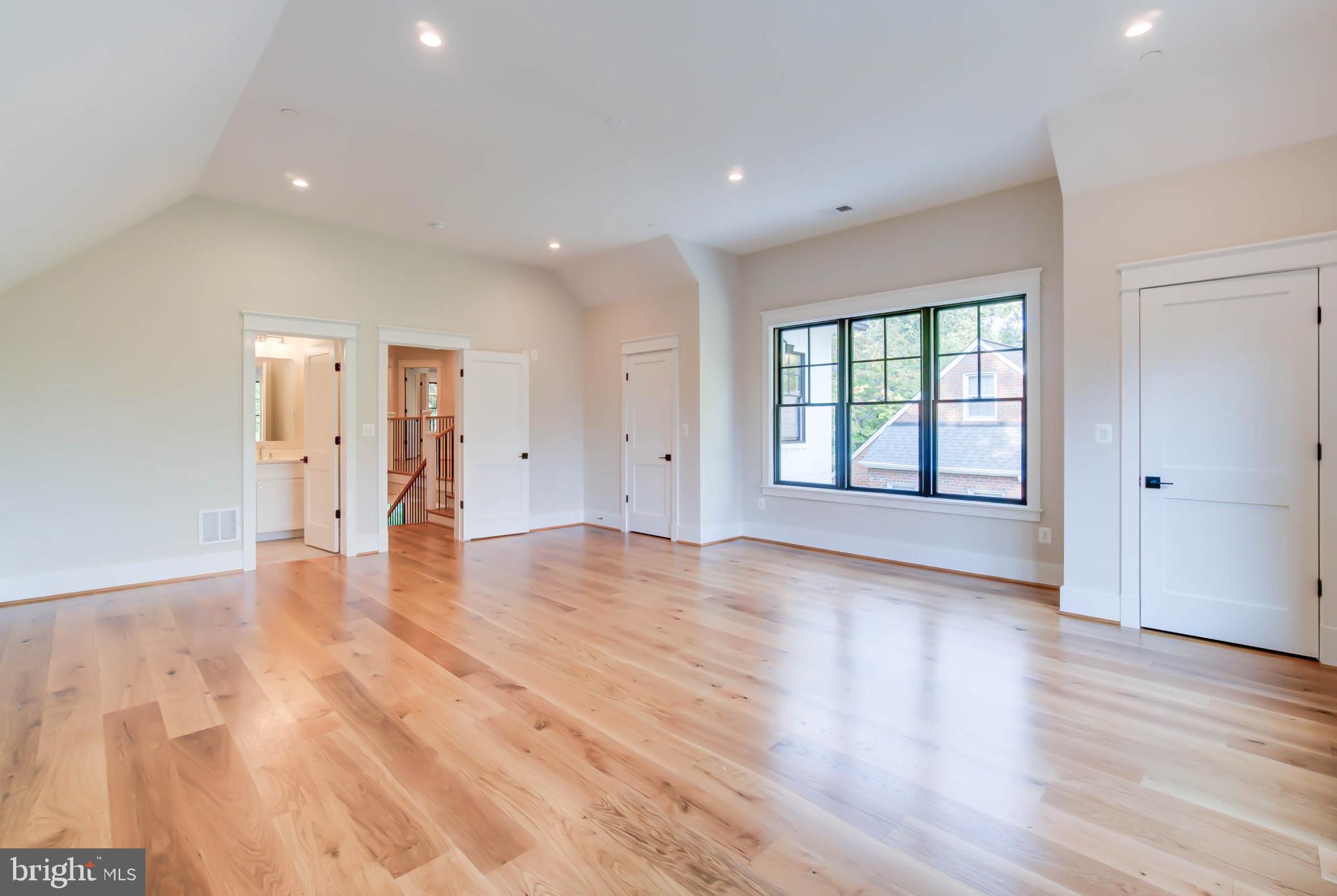 7818 Glenbrook Road Bethesda, MD 20814 - Photo 69 of 95 a view of an empty room with wooden floor and a window
