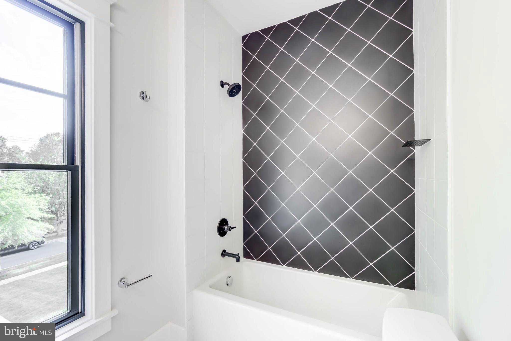7818 Glenbrook Road Bethesda, MD 20814 - Photo 75 of 95 a bathroom with a bathtub and a shower