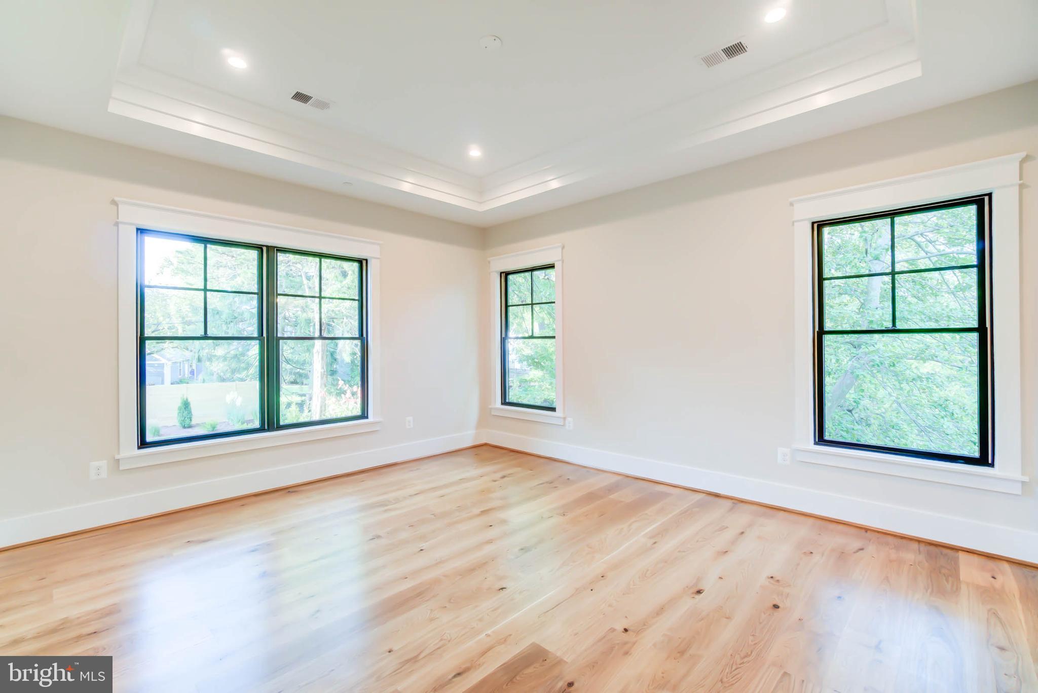 7818 Glenbrook Road Bethesda, MD 20814 - Photo 77 of 95 an empty room with wooden floor and windows