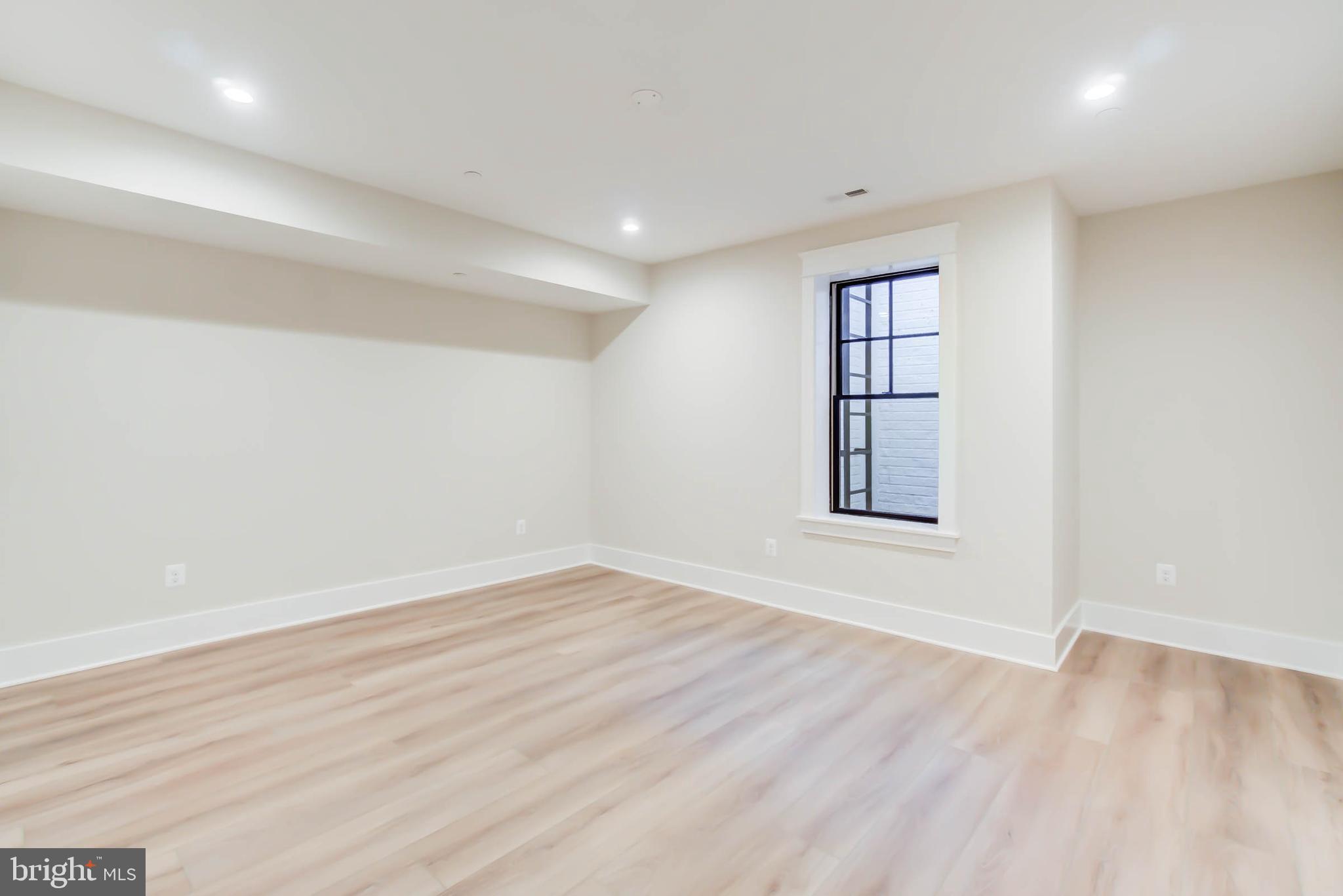 7818 Glenbrook Road Bethesda, MD 20814 - Photo 89 of 95 an empty room with wooden floor and windows