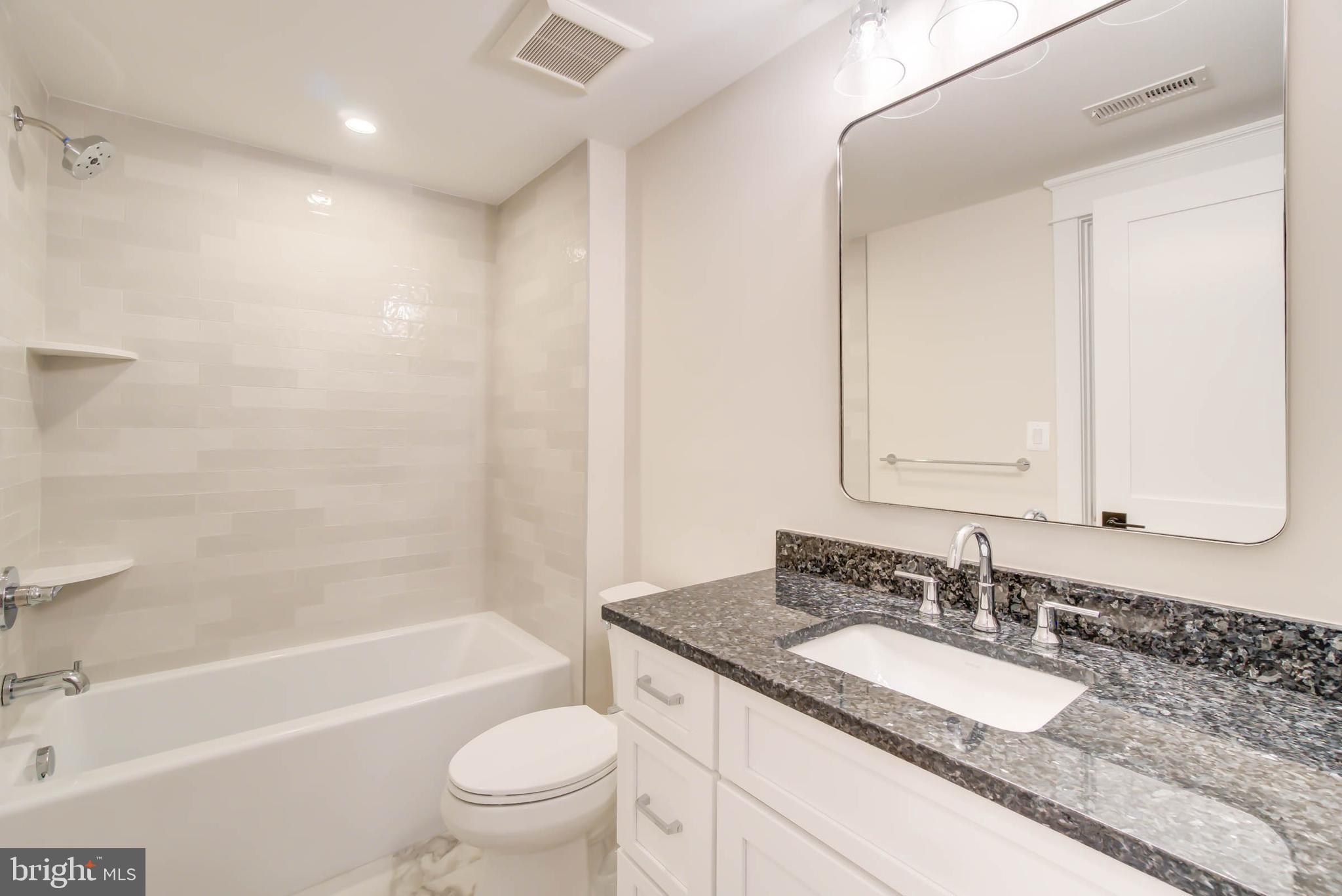 7818 Glenbrook Road Bethesda, MD 20814 - Photo 93 of 95 a bathroom with a granite countertop sink a toilet and a bathtub