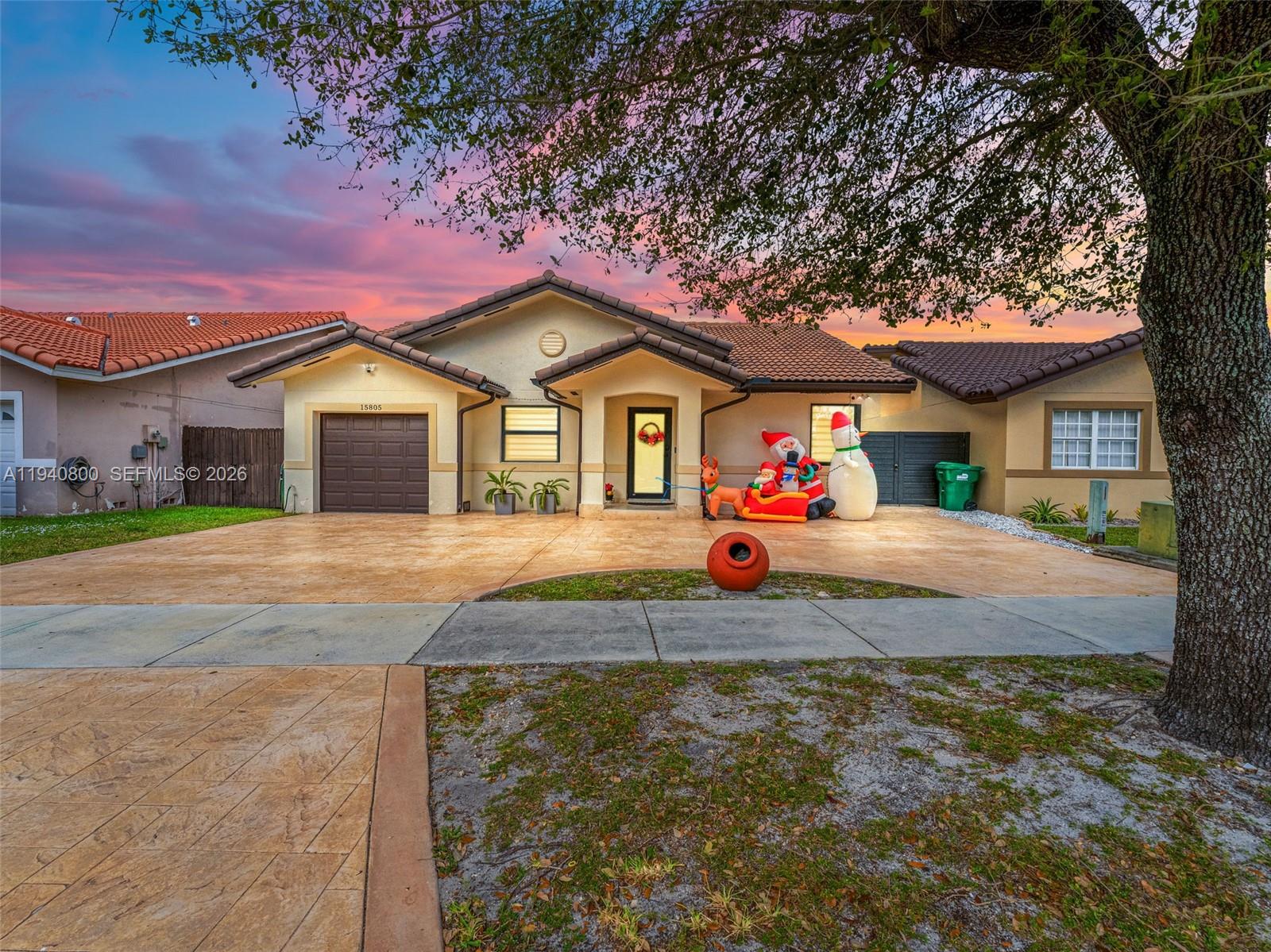 15805 Southwest 79th Terrace Miami, FL 33193 - Photo 1 of 50 a front view of a house with garden
