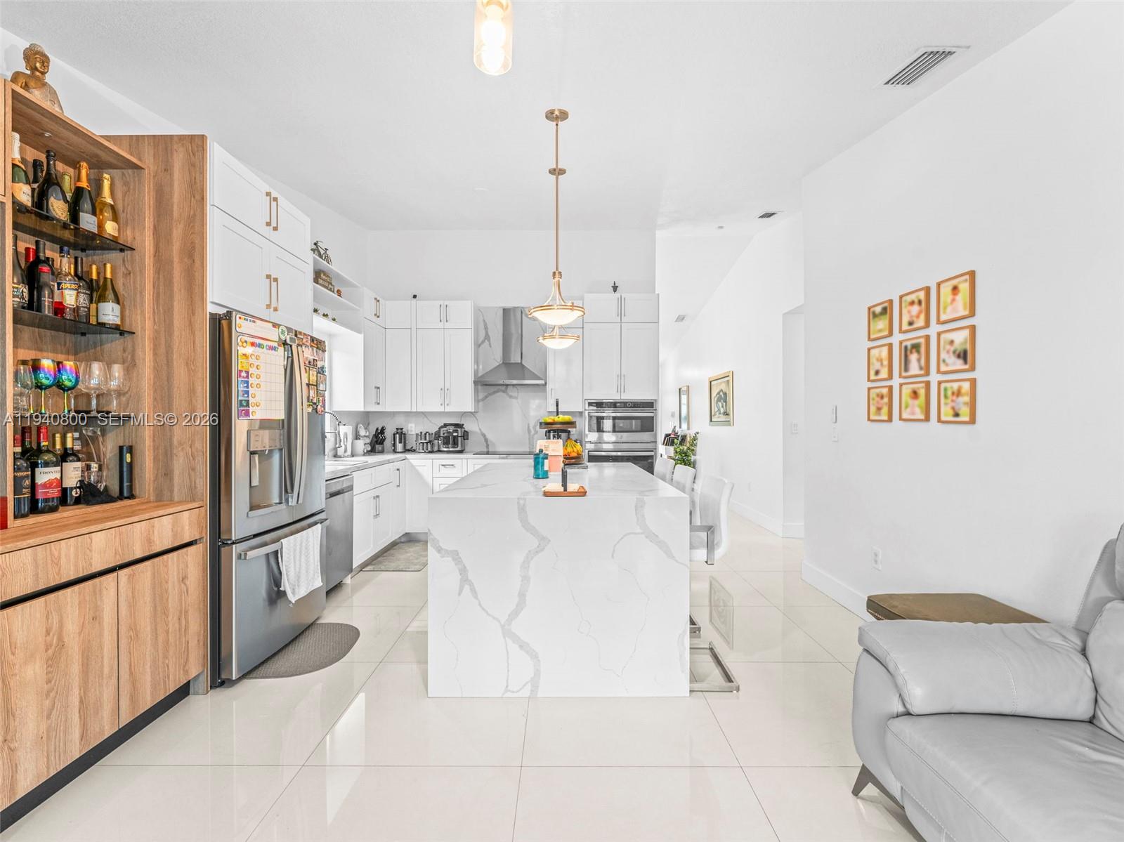 15805 Southwest 79th Terrace Miami, FL 33193 - Photo 14 of 50 a living room with stainless steel appliances furniture a rug and a kitchen view