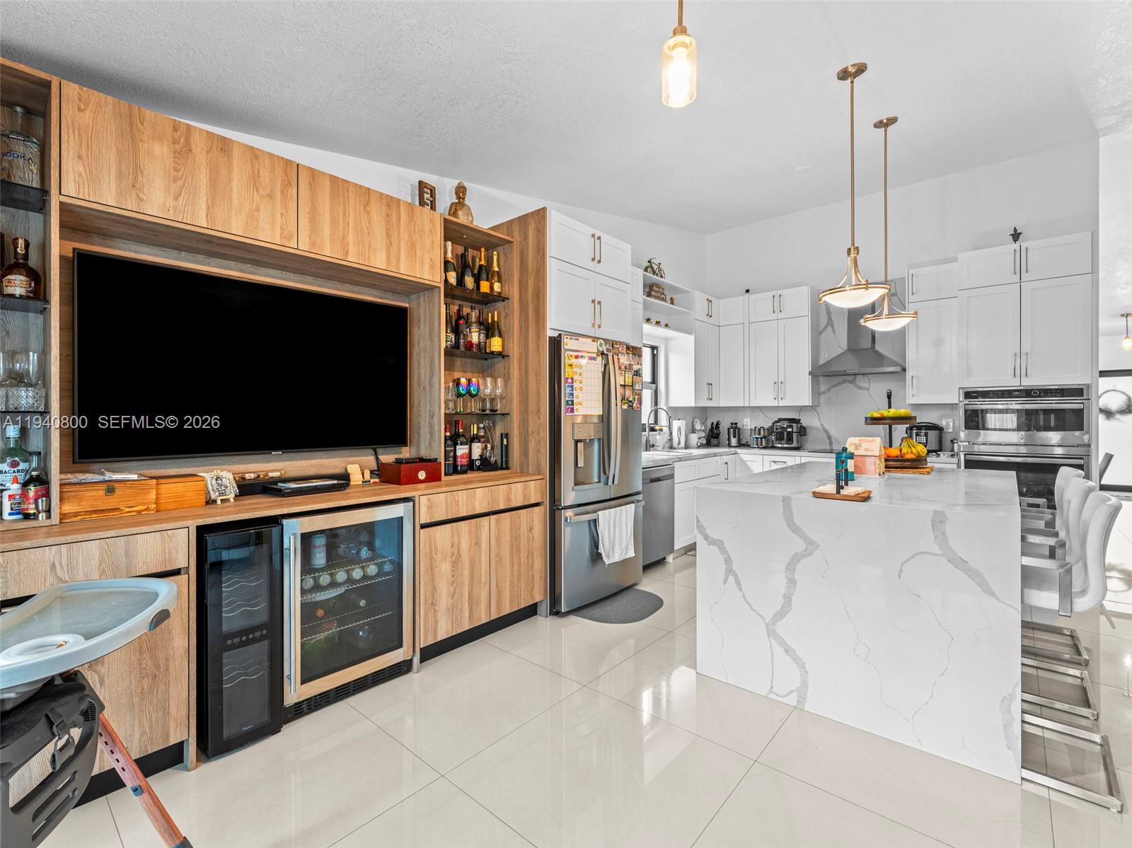 15805 Southwest 79th Terrace Miami, FL 33193 - Photo 15 of 50 a kitchen with stainless steel appliances wooden floor and a view of living room