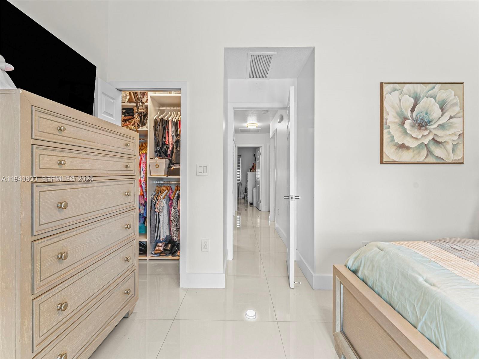 15805 Southwest 79th Terrace Miami, FL 33193 - Photo 25 of 50 a bedroom with a bed and a flat screen tv