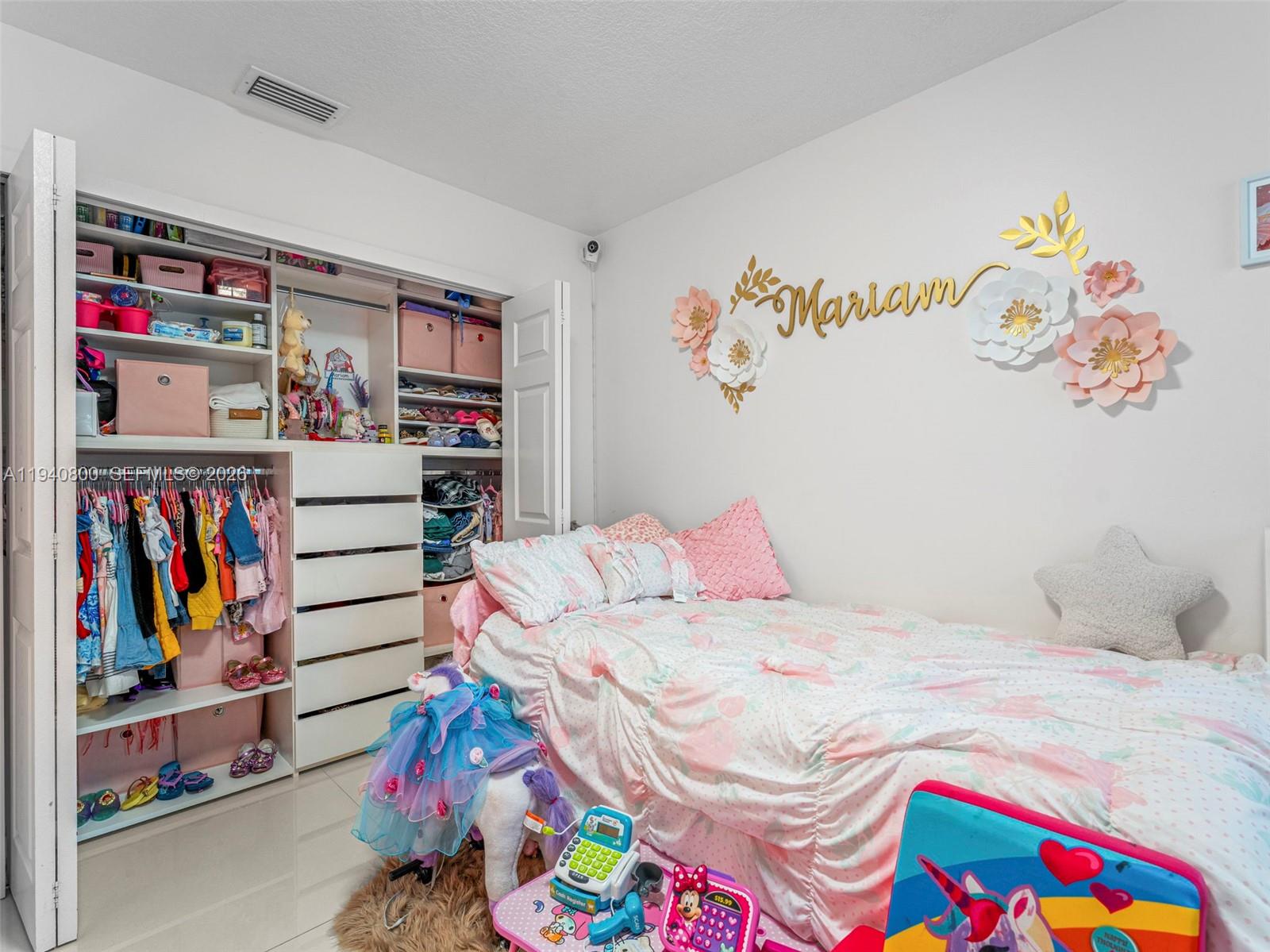 15805 Southwest 79th Terrace Miami, FL 33193 - Photo 27 of 50 a bedroom with a bed and a book shelf