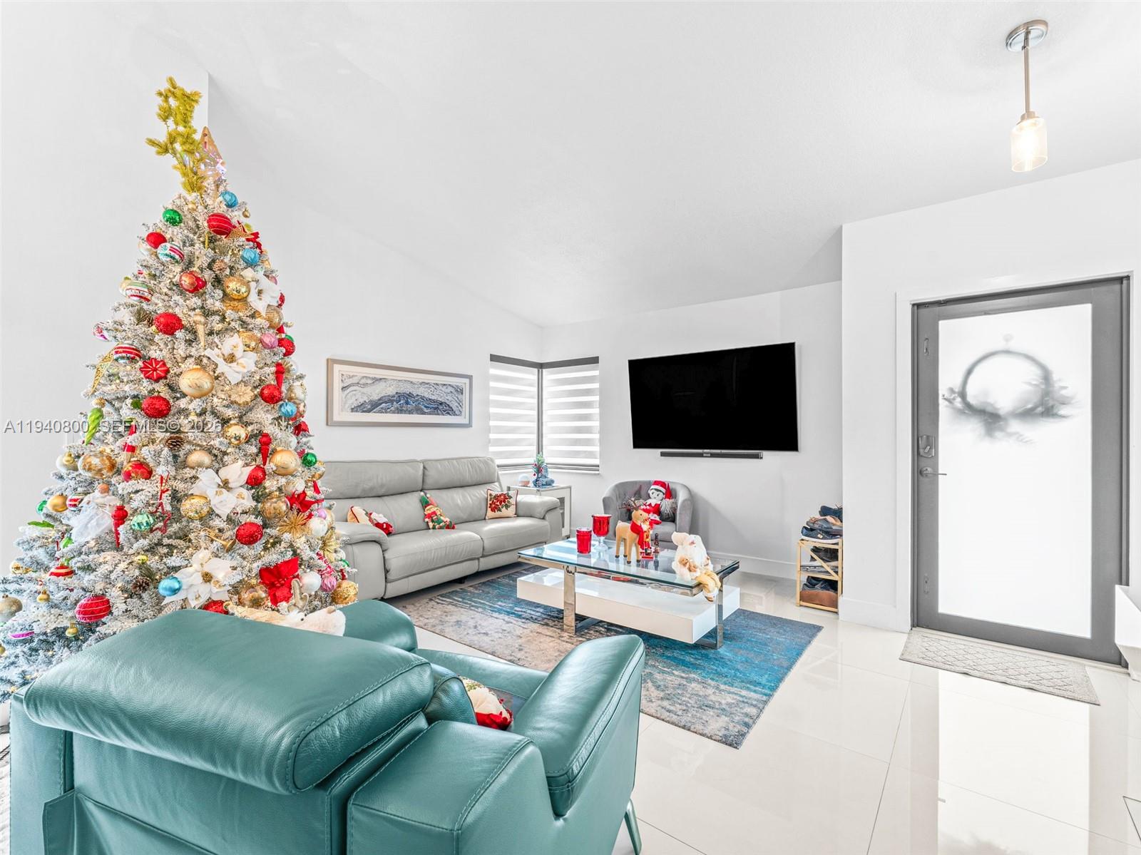 15805 Southwest 79th Terrace Miami, FL 33193 - Photo 7 of 50 a living room with furniture and a flat screen tv