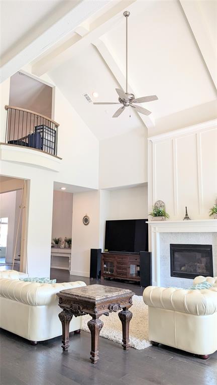 8933 Frostweed Road Frisco, TX 75035 - Photo 11 of 36 a living room with furniture a flat screen tv and a fireplace