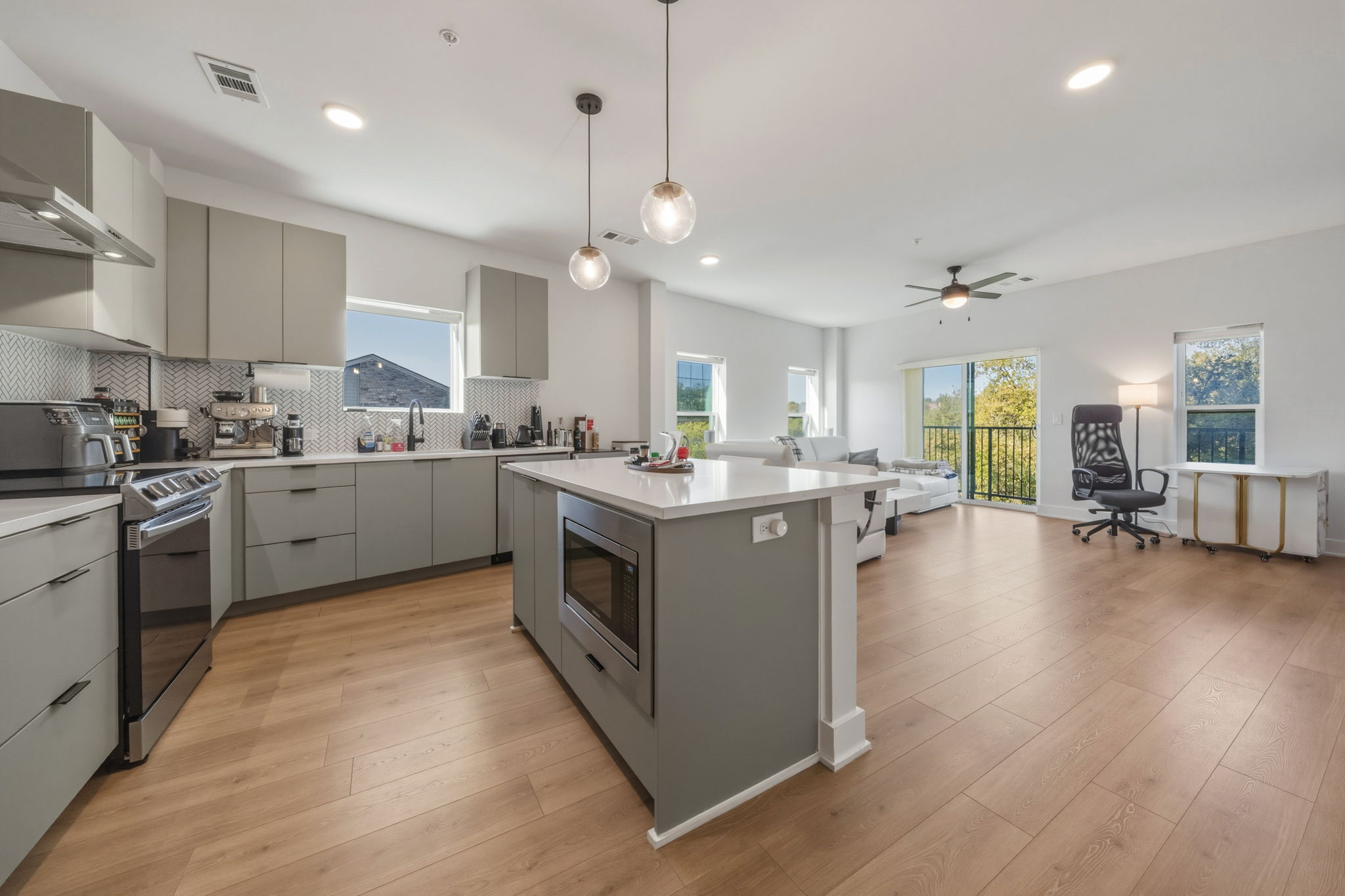 a kitchen with a sink cabinets and wooden floor