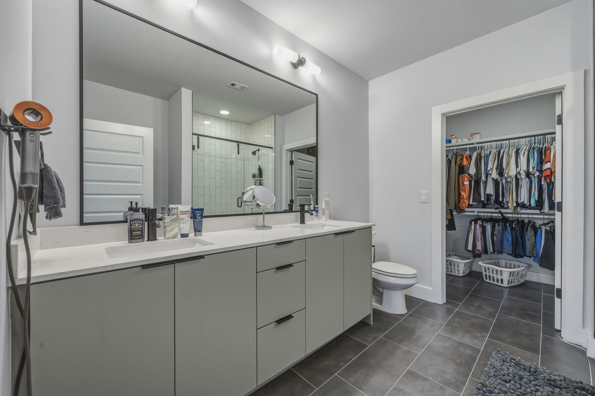 2500 Longview Street, Unit 300 Austin, TX 78705 - Photo 12 of 36 a bathroom with a double vanity sink toilet and shower