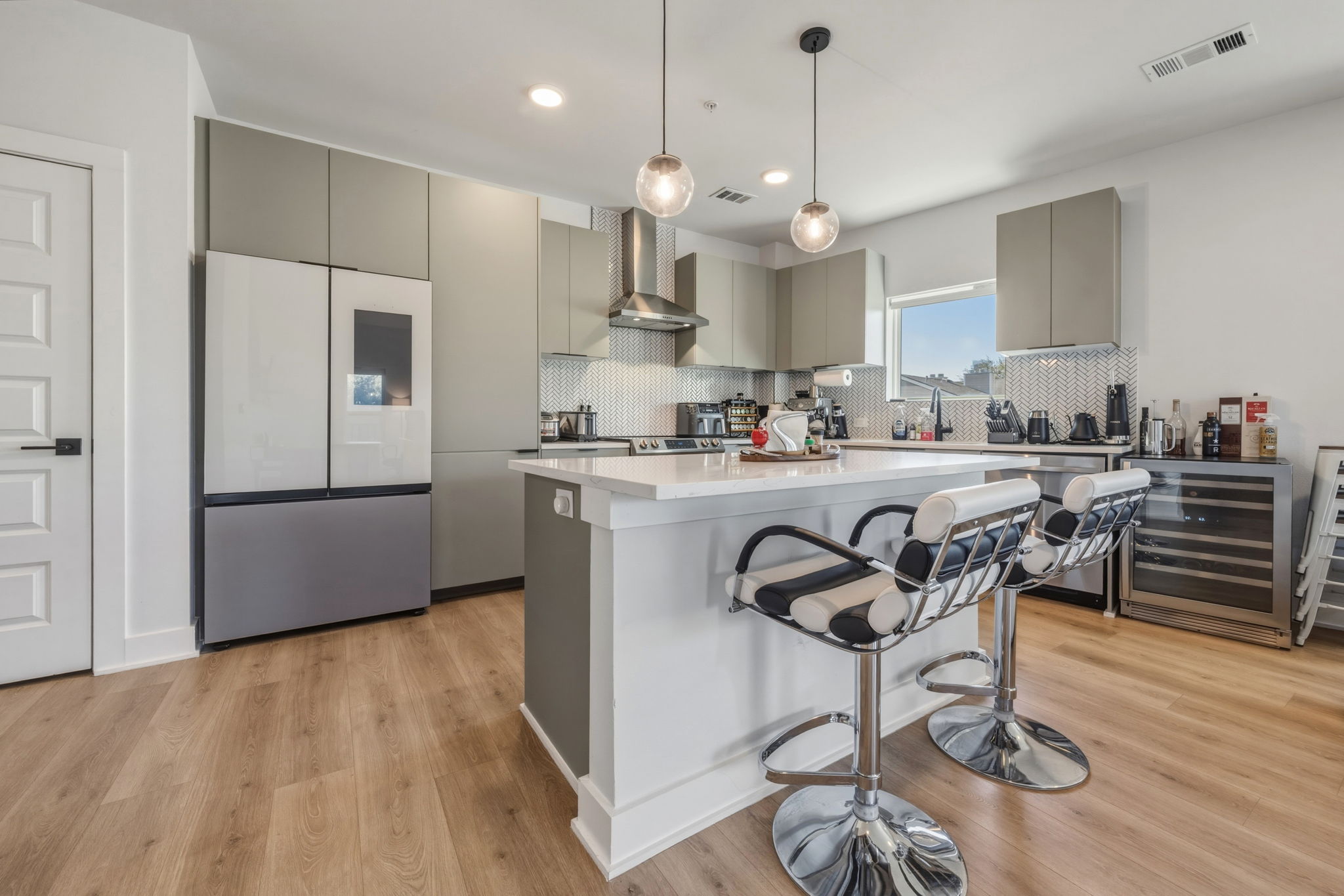 2500 Longview Street, Unit 300 Austin, TX 78705 - Photo 4 of 36 a kitchen with stainless steel appliances a stove a sink island and a refrigerator