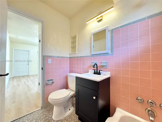 a bathroom with a sink a toilet and mirror