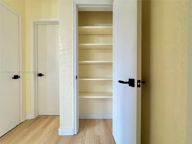 a view of a room with wooden floor