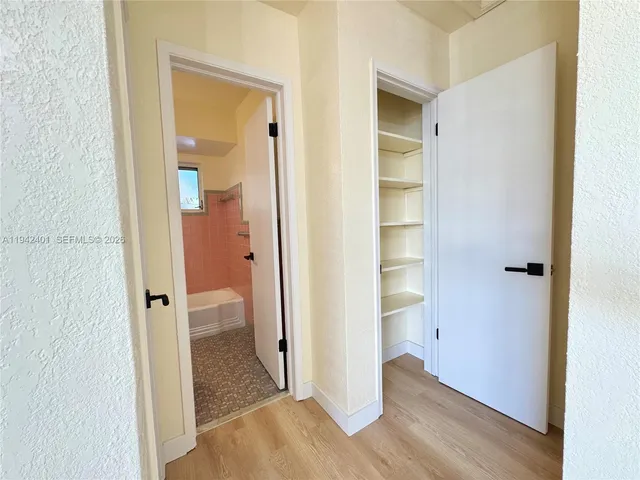 a view of a bathroom with wooden floor