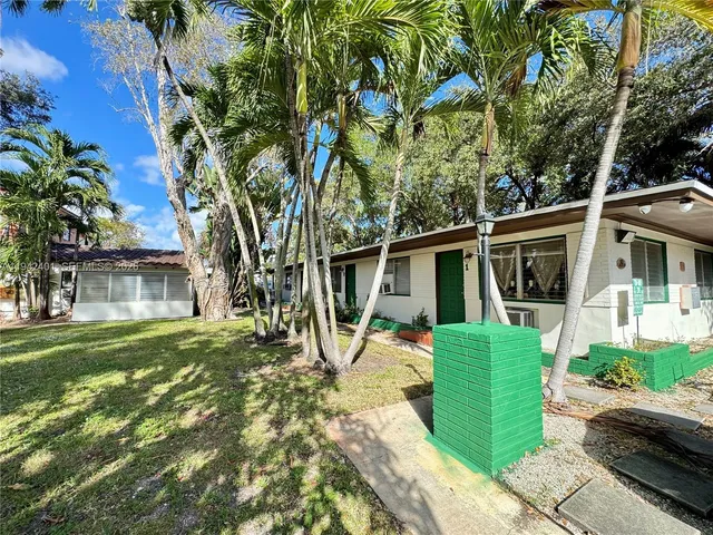 a house that has a tree in front of it