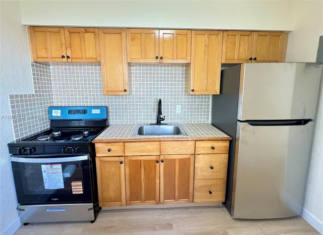 a kitchen with a stove and a refrigerator