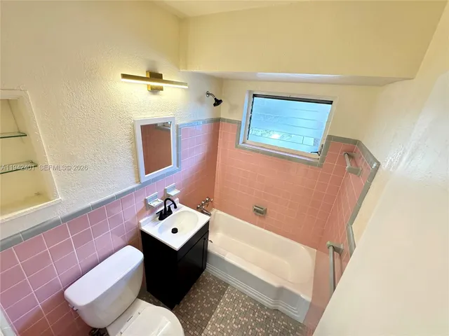 a bathroom with a bathtub sink and toilet