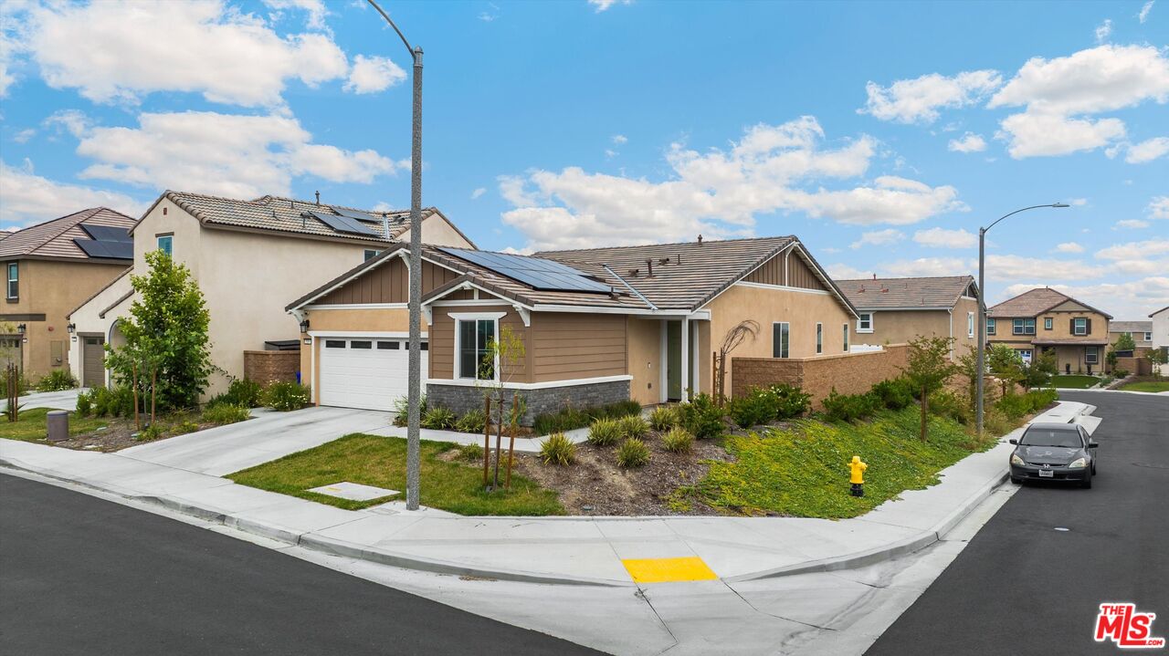 519 Tucker Avenue Rialto, CA 92377 - Photo 14 of 45 a view of a white house with a big yard and potted plants