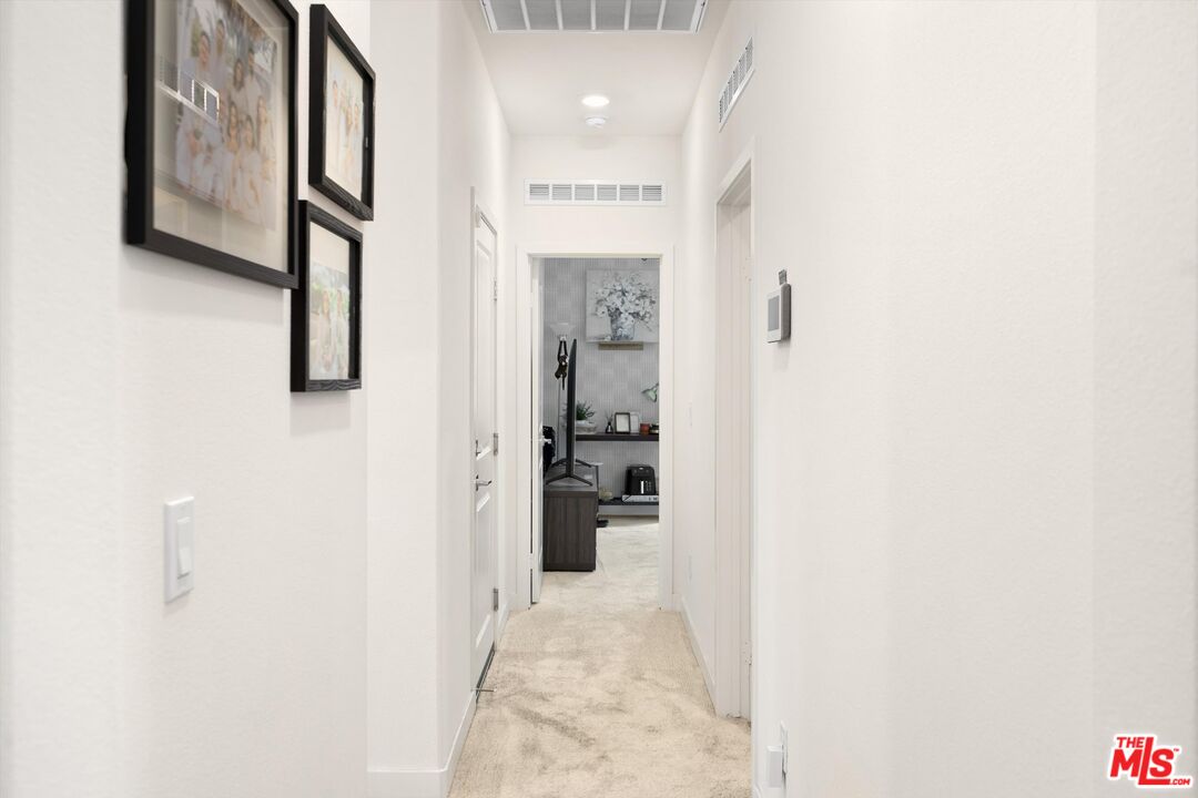 519 Tucker Avenue Rialto, CA 92377 - Photo 25 of 45 a view of a hallway with wooden floor and staircase