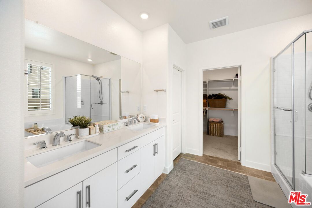 519 Tucker Avenue Rialto, CA 92377 - Photo 29 of 45 a bathroom with a double vanity sink mirror and shower