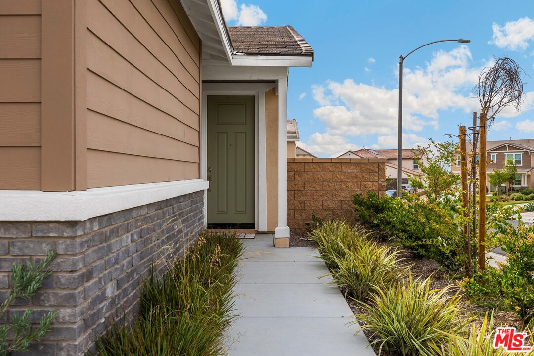 519 Tucker Avenue Rialto, CA 92377 - Photo 33 of 45 a pathway of a house with a yard