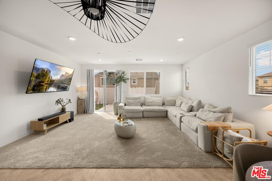 519 Tucker Avenue Rialto, CA 92377 - Photo 5 of 45 a living room with furniture wooden floor and a flat screen tv