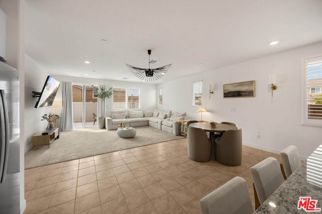 519 Tucker Avenue Rialto, CA 92377 - Photo 8 of 45 a living room with furniture and a flat screen tv