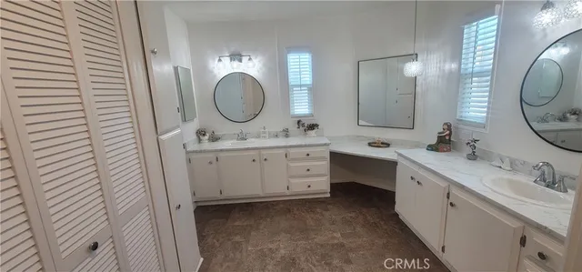 a spacious bathroom with a double vanity sink and a mirror