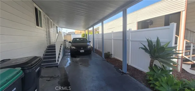 a view of a patio with couple of chairs and a potted plant