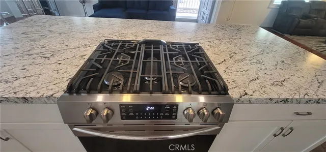 a stove top oven sitting inside of a kitchen