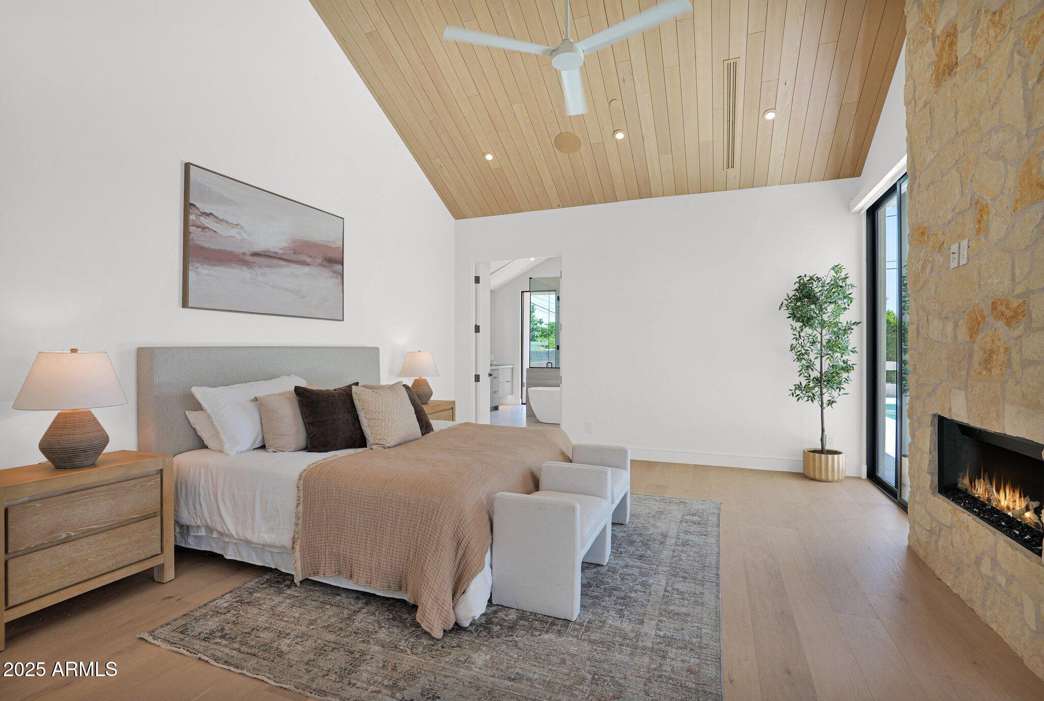 4704 North 40th Place Phoenix, AZ 85018 - Photo 32 of 65 a bedroom with bed and a potted plant