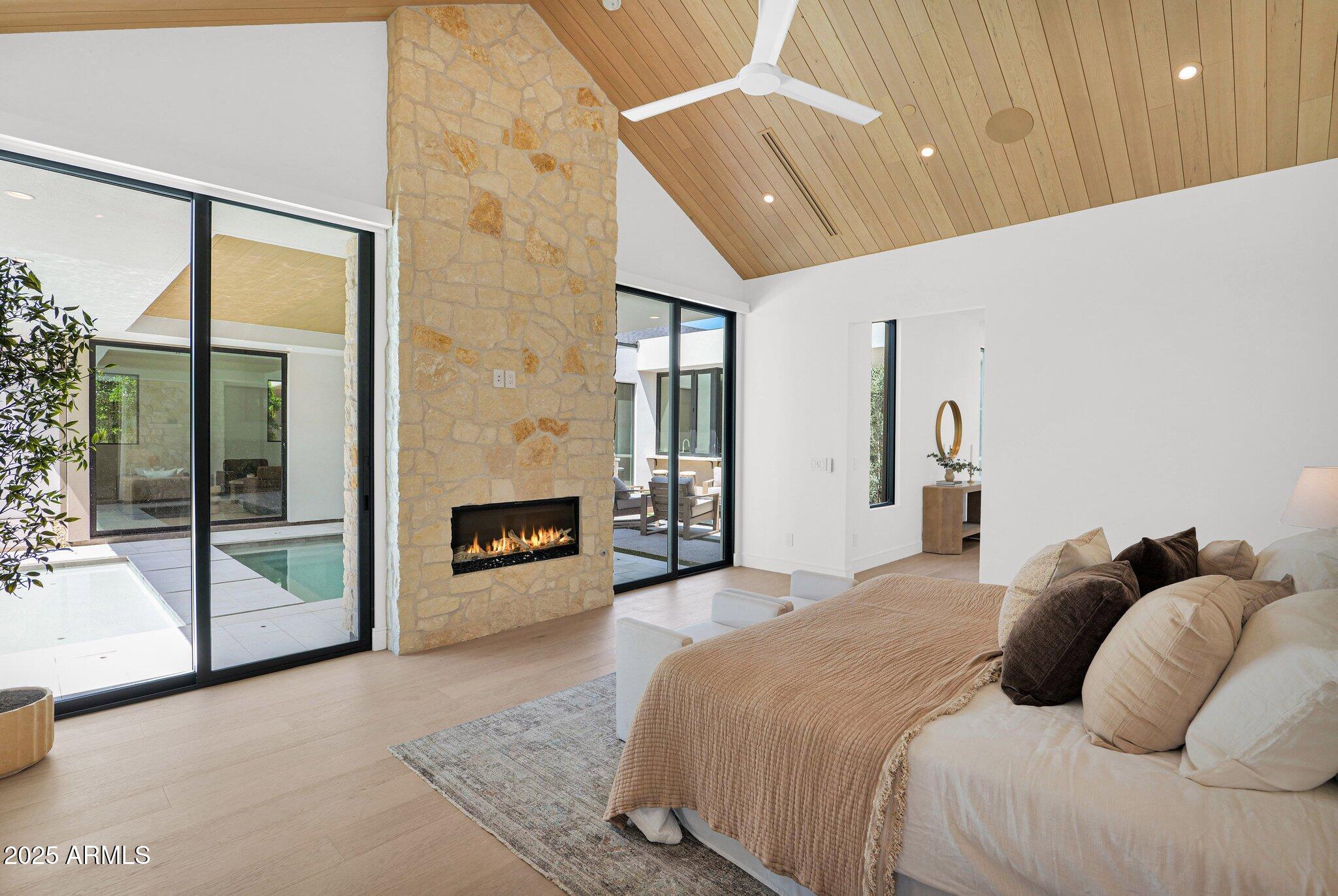 4704 North 40th Place Phoenix, AZ 85018 - Photo 34 of 65 a bedroom with a bed and a fireplace