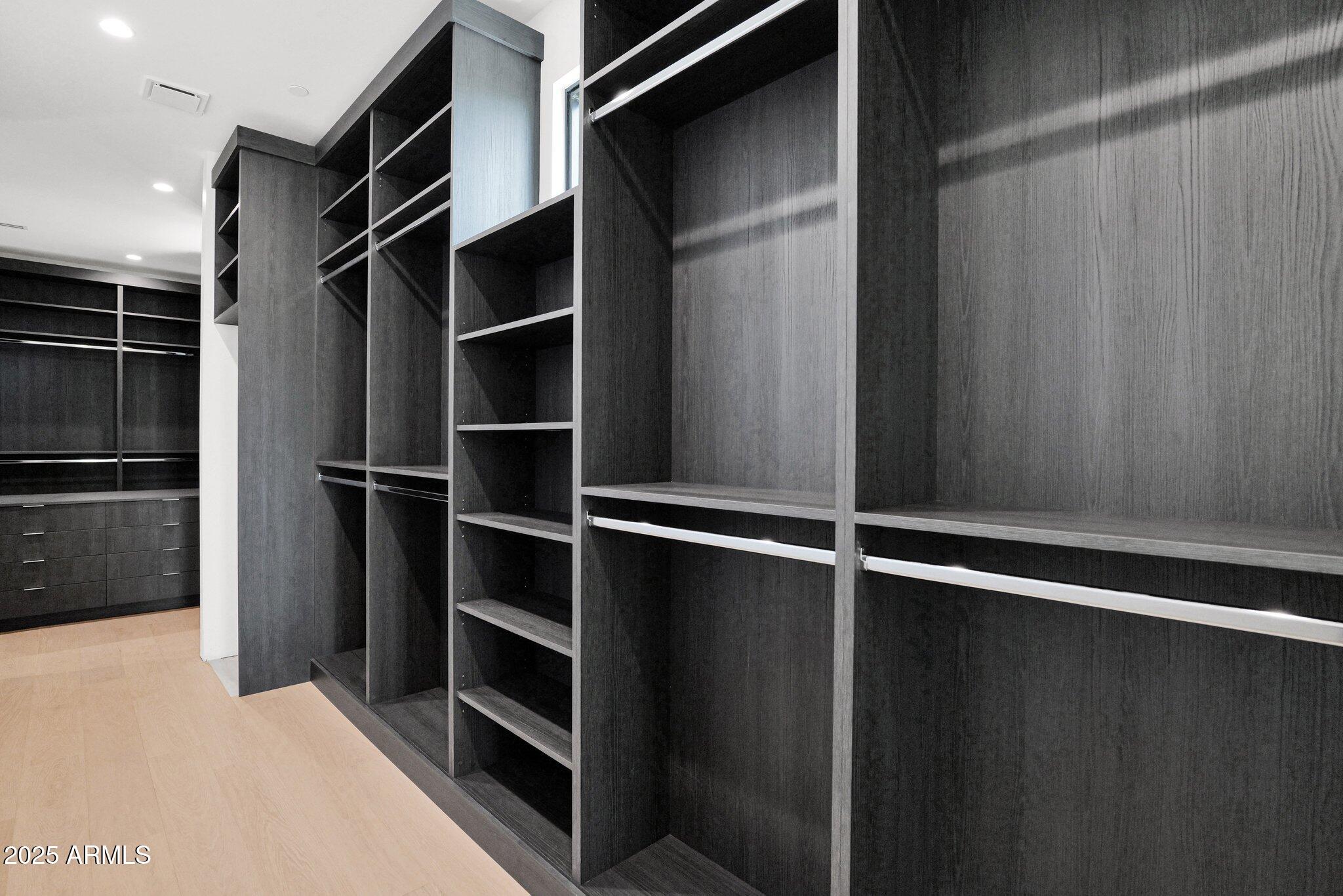 4704 North 40th Place Phoenix, AZ 85018 - Photo 35 of 65 a view of walk in closet with empty racks