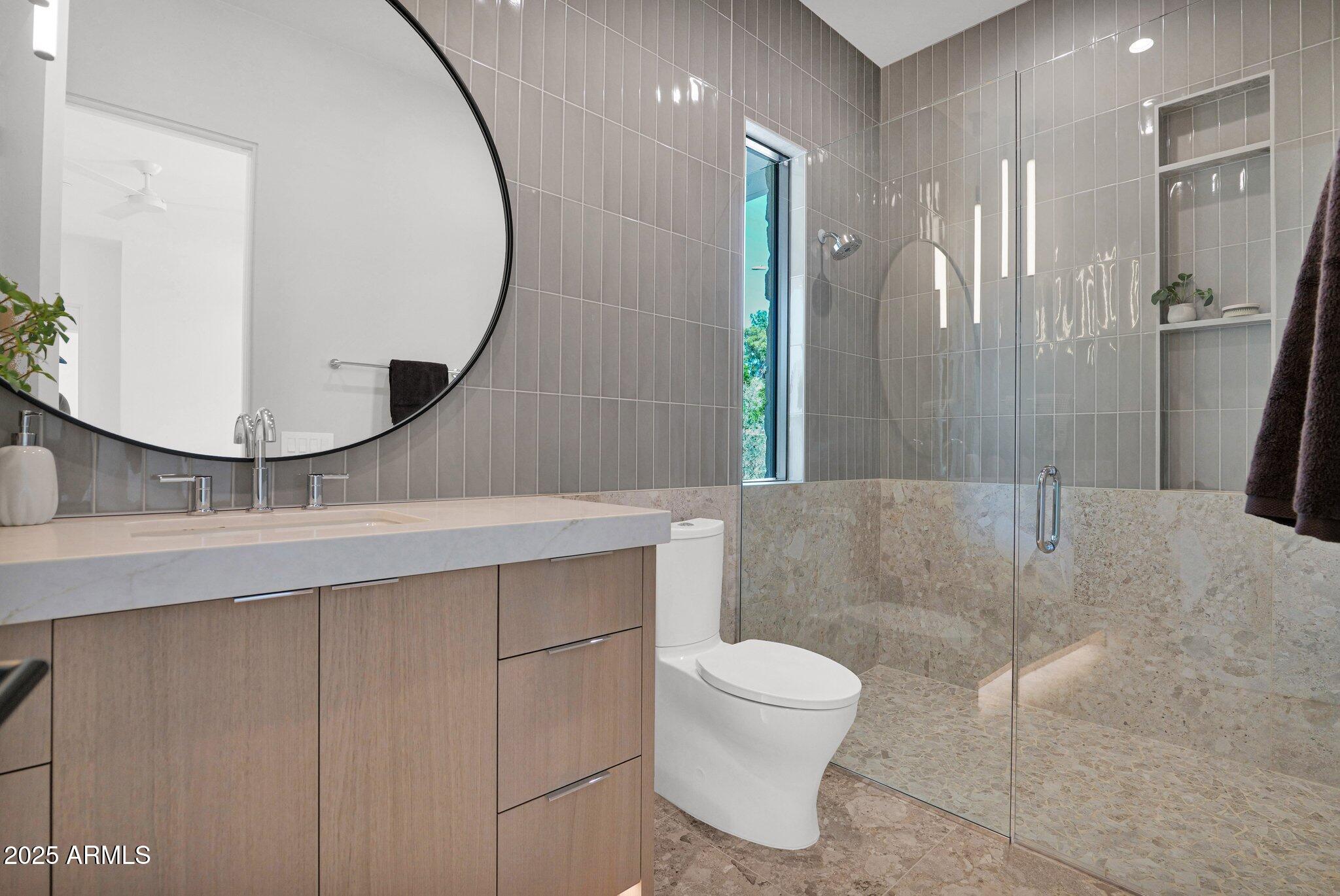 4704 North 40th Place Phoenix, AZ 85018 - Photo 41 of 65 a bathroom with a toilet a sink and mirror