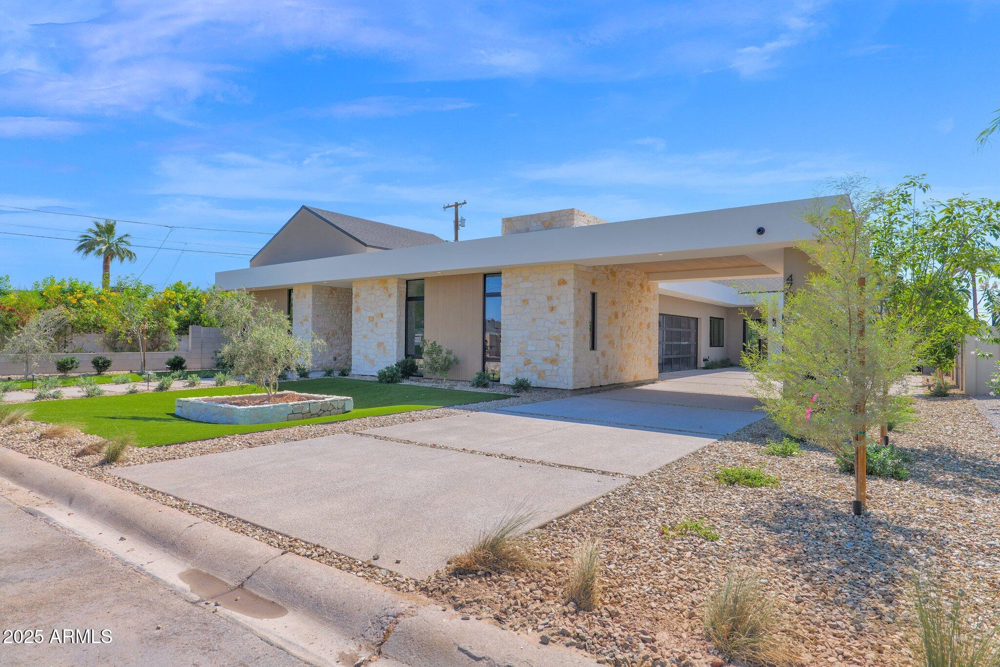 4704 North 40th Place Phoenix, AZ 85018 - Photo 4 of 65 a front view of a house with a yard and garage
