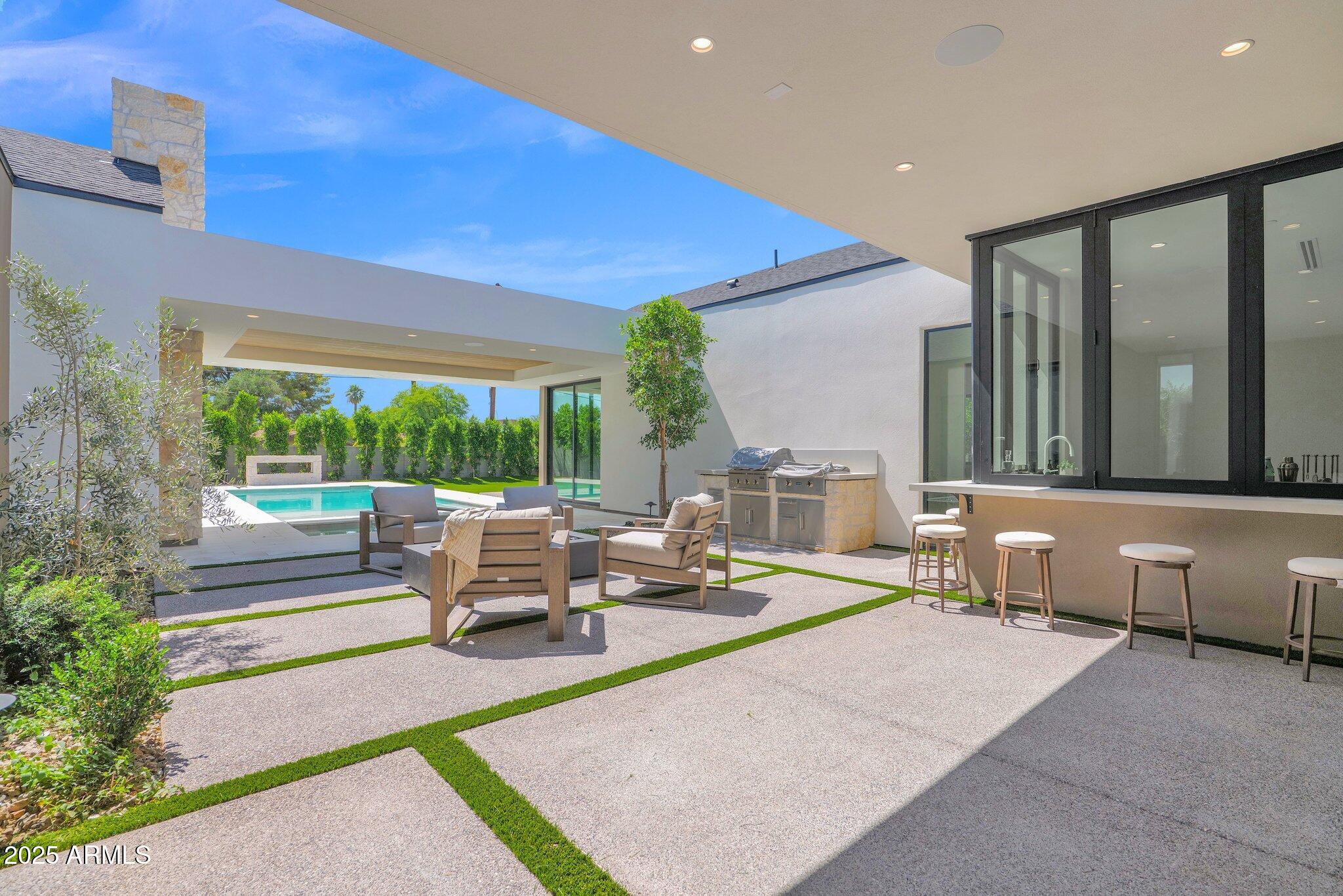 4704 North 40th Place Phoenix, AZ 85018 - Photo 54 of 65 a living room with patio furniture and a large window