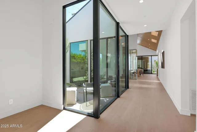 a kitchen with stainless steel appliances a table and chairs in it