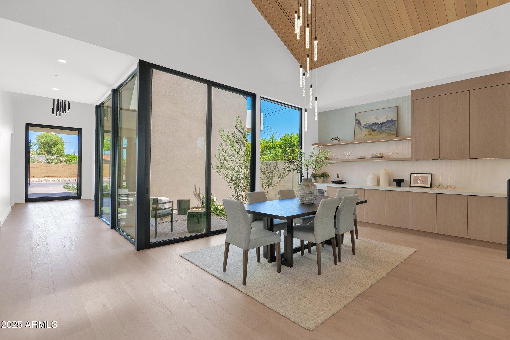 4704 North 40th Place Phoenix, AZ 85018 - Photo 7 of 65 a kitchen with stainless steel appliances a table and chairs in it