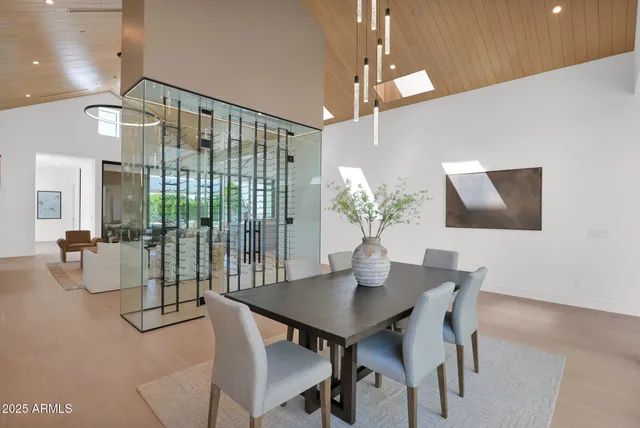 a dining room with furniture and floor to ceiling window