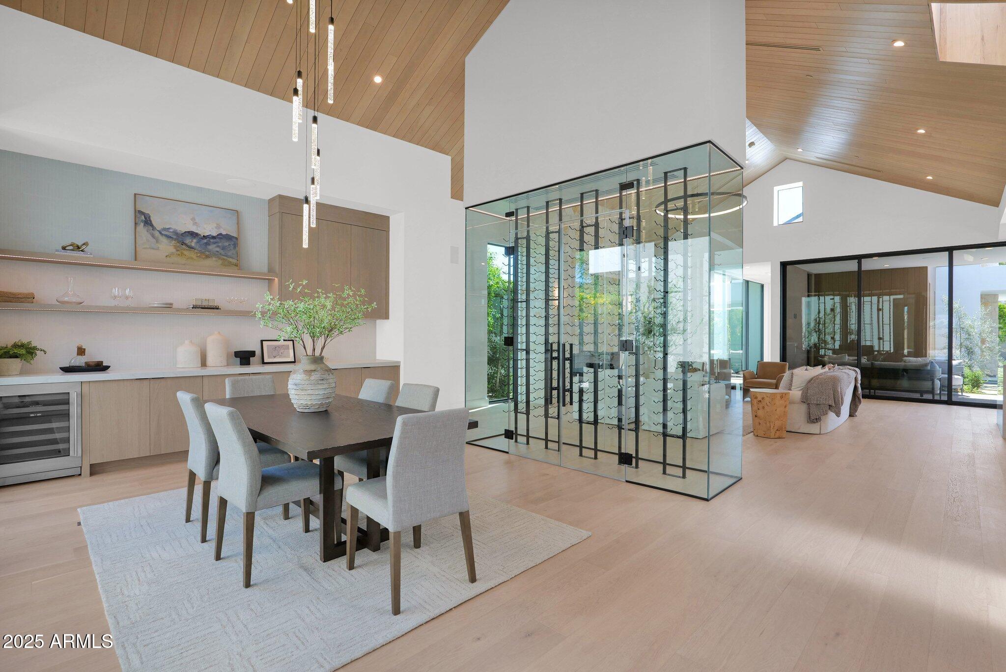 4704 North 40th Place Phoenix, AZ 85018 - Photo 9 of 65 a view of a dining room and livingroom with furniture wooden floor a chandelier