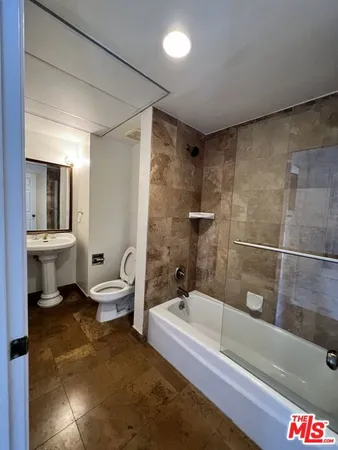 a bathroom with a bathtub and a toilet