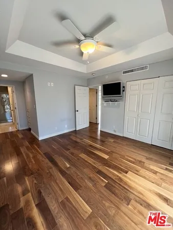a view of empty room with wooden floor