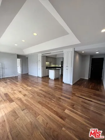 a view of empty room and kitchen