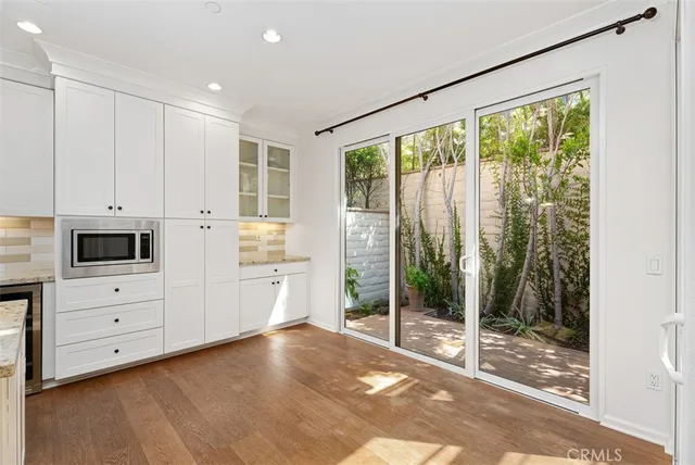 a view of a kitchen with dishwasher and white cabinets