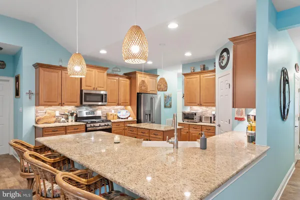 a kitchen with stainless steel appliances granite countertop a stove and a sink